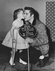 1957 Elvis bending down little girl kissing him March of Dimes