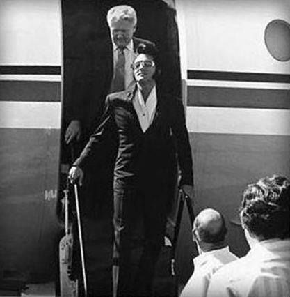 1970 Elvis candid in black with shades vernon following jet ColonelPKR bald head